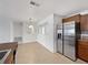 Bright kitchen and dining area featuring stainless steel refrigerator and tile floors at 10818 Cimarron St # 307, Firestone, CO 80504