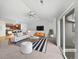 Bright living room featuring vaulted ceilings, a modern fan, a stylish rug, and an open-concept design at 10818 Cimarron St # 307, Firestone, CO 80504