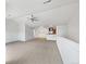 Open living area showcasing neutral tones, modern ceiling fan, and seamless flow to the kitchen at 10818 Cimarron St # 307, Firestone, CO 80504