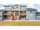 Charming townhomes with private balconies and manicured front lawns create a welcoming curb appeal at 883 Widgeon Cir, Longmont, CO 80503