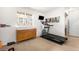 Home gym area with a treadmill, dresser, and window at 883 Widgeon Cir, Longmont, CO 80503