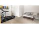 Exercise room featuring a treadmill and comfortable sofa at 883 Widgeon Cir, Longmont, CO 80503