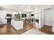 Open kitchen with a center island, stainless appliances and views to the dining and living rooms at 883 Widgeon Cir, Longmont, CO 80503