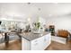 Open-concept living space featuring a kitchen island with stylish pendant lighting and seamless transition to the dining area at 883 Widgeon Cir, Longmont, CO 80503