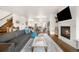 Open-concept living space featuring hardwood floors, a fireplace, and a seamless transition to the kitchen at 883 Widgeon Cir, Longmont, CO 80503