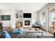 Bright living room features a modern fireplace, hardwood floors, and a sliding glass door to the balcony at 883 Widgeon Cir, Longmont, CO 80503