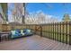 Inviting back deck with wood flooring, a wooden fence, and comfortable outdoor seating with colorful cushions at 3850 Paseo Del Prado # 29, Boulder, CO 80301