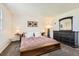Bedroom featuring a decorative accent wall, and a dresser with a mirror at 3850 Paseo Del Prado # 29, Boulder, CO 80301