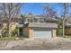 Charming townhome featuring a brick facade and attached garage, with mature trees surrounding the property at 3850 Paseo Del Prado # 29, Boulder, CO 80301