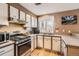 Updated kitchen with stainless steel appliances, granite countertops, modern cabinetry, and hardwood flooring at 3850 Paseo Del Prado # 29, Boulder, CO 80301