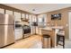 Modern kitchen featuring stainless steel appliances, white cabinetry, granite countertops, and hardwood flooring at 3850 Paseo Del Prado # 29, Boulder, CO 80301