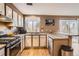Well-equipped kitchen with stainless steel appliances, granite countertops, hardwood floors, and a view to the outside at 3850 Paseo Del Prado # 29, Boulder, CO 80301