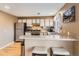 Well-lit kitchen featuring stainless steel appliances, granite countertops, and a breakfast bar with seating for two at 3850 Paseo Del Prado # 29, Boulder, CO 80301