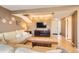 Bright living room featuring a large sectional sofa, hardwood floors, a TV setup, and decorative wall hangings at 3850 Paseo Del Prado # 29, Boulder, CO 80301
