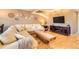 Cozy living room showcasing a large sectional sofa, hardwood floors, a modern TV setup, and decorative wall art at 3850 Paseo Del Prado # 29, Boulder, CO 80301