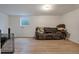 Spacious basement with sofa, a window and durable laminate flooring at 1235 S Monaco Pkwy, Denver, CO 80224