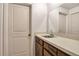 Small bathroom with a dark wood cabinet, sink and mirror at 1235 S Monaco Pkwy, Denver, CO 80224