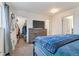 Spacious bedroom featuring carpet, television, dresser, a walk-in closet and doorways at 1235 S Monaco Pkwy, Denver, CO 80224