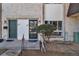 Close up of charming townhouse with brick and stucco facade and landscaped area at 1235 S Monaco Pkwy, Denver, CO 80224