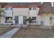 Inviting exterior of townhome featuring brick facade, well-kept landscaping and a welcoming walkway at 1235 S Monaco Pkwy, Denver, CO 80224