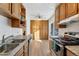 Bright kitchen with light wood cabinets and granite counters at 1235 S Monaco Pkwy, Denver, CO 80224