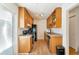 Galley kitchen featuring wooden cabinets and stainless steel appliances at 1235 S Monaco Pkwy, Denver, CO 80224