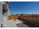 Private back patio with a stamped concrete area, wood fence and neighborhood views at 9501 Richfield St, Commerce City, CO 80022