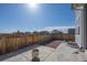 Concrete patio, fenced yard, and view of neighborhood homes on a sunny day at 9501 Richfield St, Commerce City, CO 80022