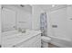 Clean bathroom featuring a single sink vanity with a marble countertop and shower-tub combo at 9501 Richfield St, Commerce City, CO 80022