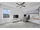 Modern bedroom with lofted bed and study area, large windows, and cozy gray carpeting at 9501 Richfield St, Commerce City, CO 80022