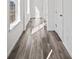 Bright entryway showcasing hardwood flooring, white walls, and natural light from nearby windows at 9501 Richfield St, Commerce City, CO 80022