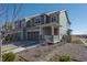 A two story home with gray siding, a welcoming front porch and an attached garage at 9501 Richfield St, Commerce City, CO 80022