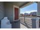 Cozy front porch featuring a seating area, a checkerboard mat, and neighborhood views at 9501 Richfield St, Commerce City, CO 80022