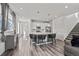 Modern kitchen with an island, white cabinets, stainless steel appliances, and bar stool seating at 9501 Richfield St, Commerce City, CO 80022