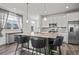 Kitchen island featuring granite countertops, a breakfast bar, and pendant lighting at 9501 Richfield St, Commerce City, CO 80022