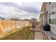 The spacious fenced backyard features a patio with seating and grass, perfect for outdoor gatherings and activities at 2033 E 167Th Way, Thornton, CO 80602