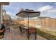 Outdoor patio with a striped umbrella, dining set, and privacy fence is ideal for relaxed outdoor living at 2033 E 167Th Way, Thornton, CO 80602