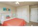This bedroom features neutral walls, carpet, a sliding door closet, and a white headboard at 2033 E 167Th Way, Thornton, CO 80602