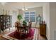 Bright dining room featuring hardwood floors, a large window, and stylish furniture at 2033 E 167Th Way, Thornton, CO 80602
