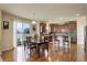 Eat-in kitchen featuring wood floors, stainless appliances, and backyard access at 2033 E 167Th Way, Thornton, CO 80602