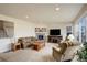 Bright living room featuring a fireplace, neutral tones, and plush seating at 2033 E 167Th Way, Thornton, CO 80602