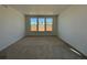 Spacious carpeted bedroom with natural light from a large window at 737 Raindance St, Erie, CO 80516