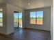 Bright dining room featuring wood floors, and a sliding glass door to the patio at 737 Raindance St, Erie, CO 80516