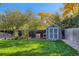 This backyard features a shed, garden boxes, lush trees, and a privacy fence at 6642 S Pearl St, Centennial, CO 80121