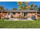 This backyard features a patio, seating, a grill, a firepit, and mature trees at 6642 S Pearl St, Centennial, CO 80121