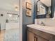 Stylish bathroom featuring a modern vanity, white backsplash and view into the bedroom at 6642 S Pearl St, Centennial, CO 80121