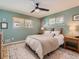 Calming bedroom with soft green walls, ceiling fan and natural light from two windows at 6642 S Pearl St, Centennial, CO 80121