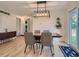 Sunlit dining room boasting a wood table, stylish chairs, and wood floors at 6642 S Pearl St, Centennial, CO 80121