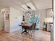 Bright dining area featuring a wood table, modern lighting fixture, and sliding glass door at 6642 S Pearl St, Centennial, CO 80121