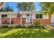 Charming home with a well-manicured lawn, attractive landscaping, and a welcoming porch at 6642 S Pearl St, Centennial, CO 80121